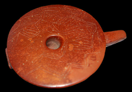 Large engraved Mississippian disc pipe from Arkansas.