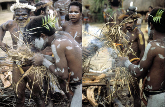 Dani man making fire to heat cooking stones.