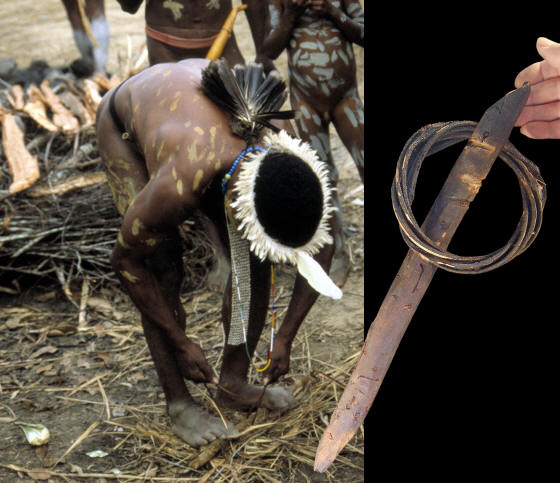 Dani man making fire with fire thong to heat cooking stones.