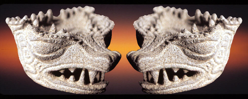 Stone carved serpent heads from a ceremonial metate.