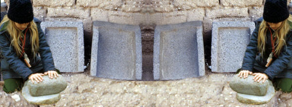 Abstract image of metates and girl demonstrating use of.
