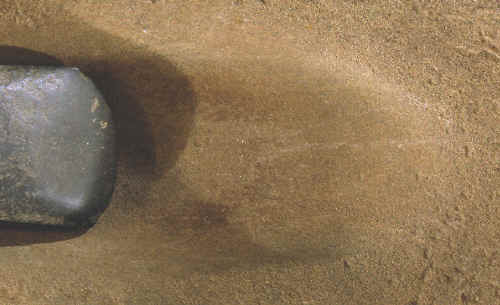 Axe sharpening stone, groove and axe bit.